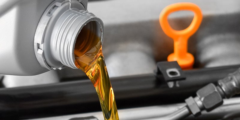 Tom Clark Chevrolet in Denton TX close up of oil being poured into engine